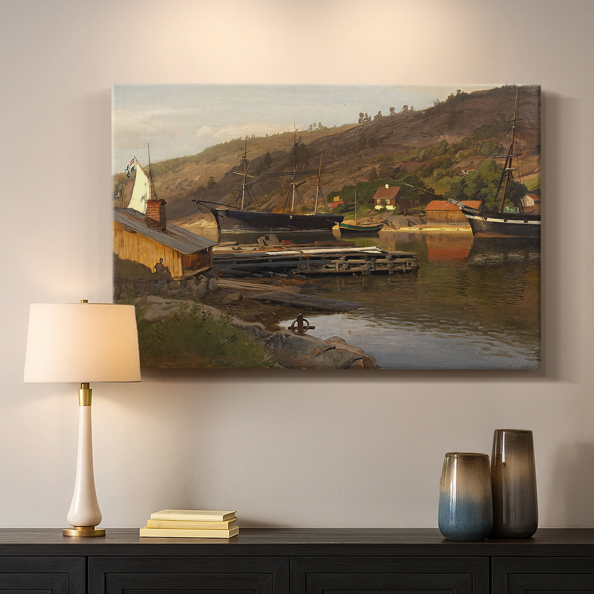 Canvas art print detailing a tranquil harbor landscape with nautical activity, mounted in a softly lit interior space