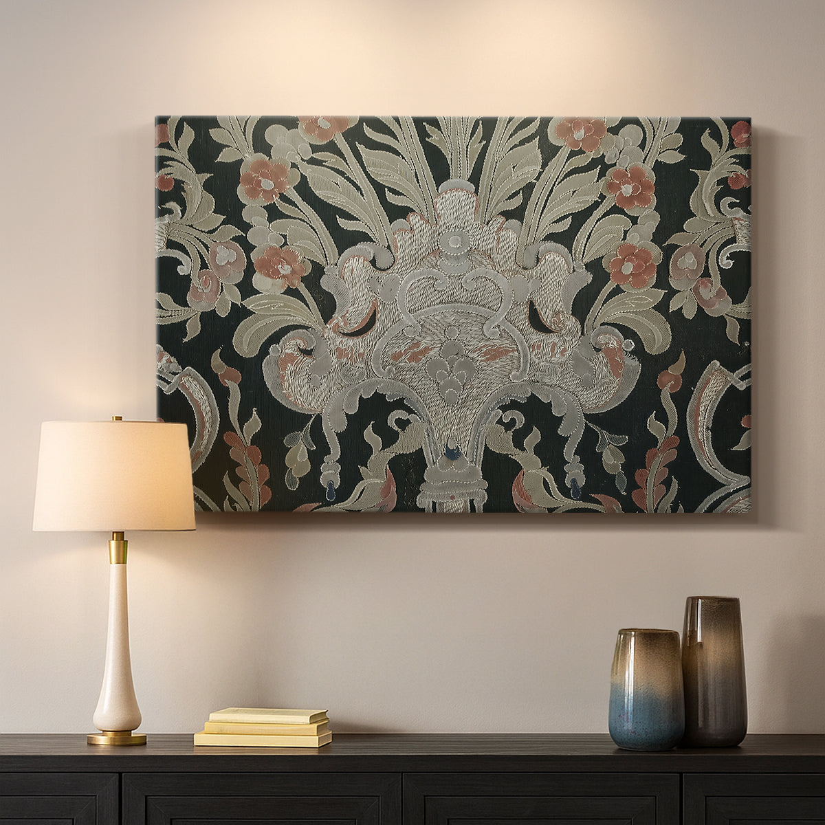 Canvas art print detailing a decorative fabric pattern with mixed botanical and animal forms, mounted in a softly lit interior space