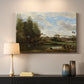Canvas art print detailing a tranquil outdoor setting with washerwomen and river, mounted in a softly lit interior space
