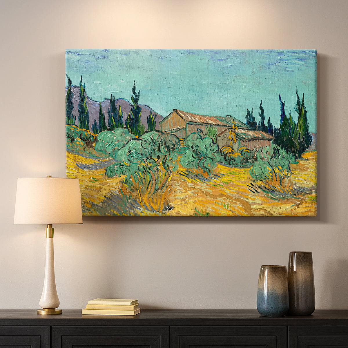 Canvas art print detailing a stylized rural setting with trees and structures, mounted in a softly lit interior space