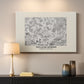 Canvas art print detailing a textile-style floral composition with repeating motifs, mounted in a softly lit interior space