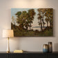 Canvas art print detailing a countryside setting with river and tree-lined banks, mounted in a softly lit interior space