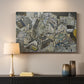 Canvas art print detailing a stylized urban composition with geometric structures and muted tones, mounted in a softly lit interior space