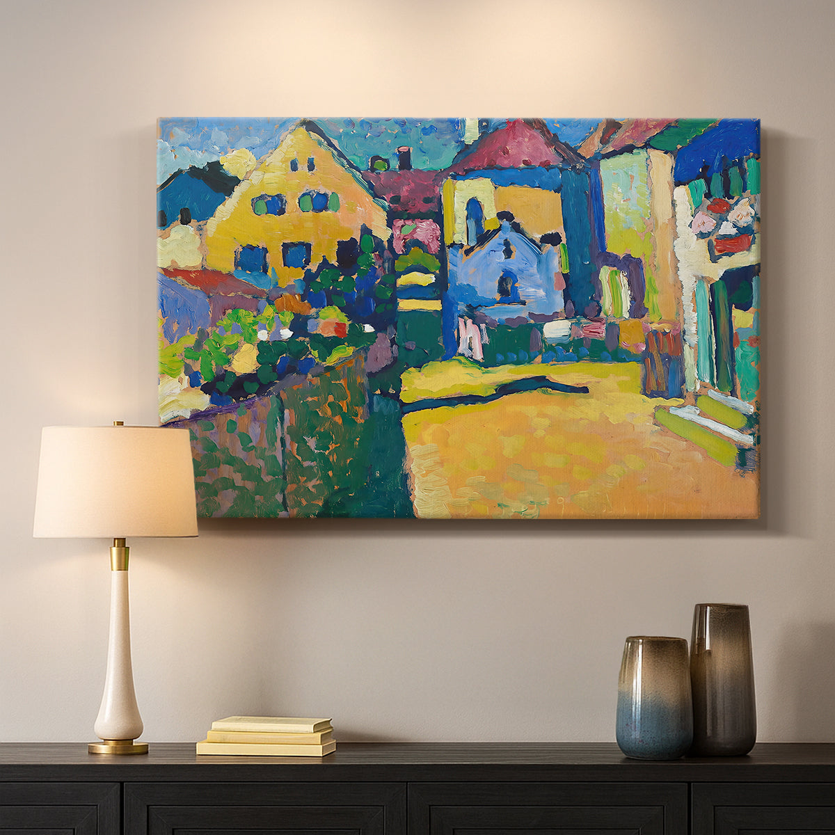 Canvas art print detailing a countryside street view with houses and greenery in vibrant tones, mounted in a softly lit interior space
