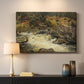 Canvas art print detailing a forested setting with stream descending over rocks, mounted in a softly lit interior space