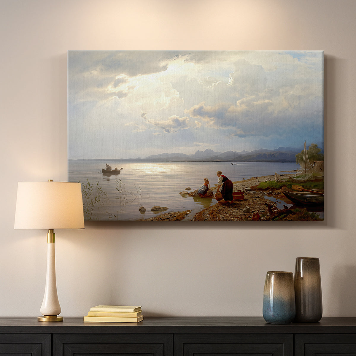 Canvas art print detailing a calm landscape with shoreline activity and soft sky, mounted in a softly lit interior space