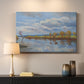 Canvas art print detailing a tranquil composition with riverbank, mounted in a softly lit interior space