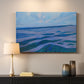 Canvas art print detailing a stylized coastal scene with layered horizontal composition, mounted in a softly lit interior space