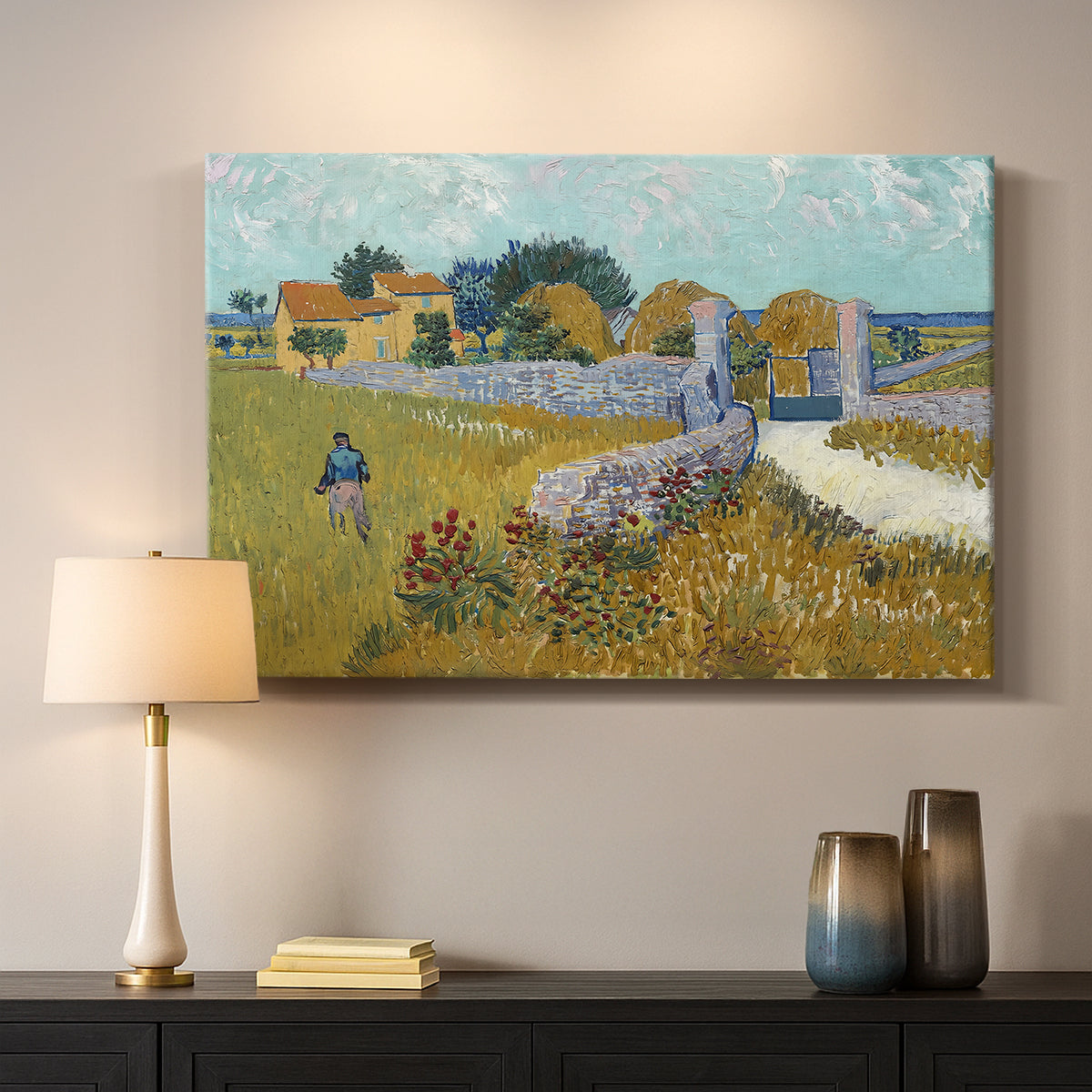 Canvas art print detailing a landscape centered on structure within bright field, mounted in a softly lit interior space