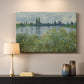 Canvas art print detailing a natural landscape with calm water and soft foliage, mounted in a softly lit interior space
