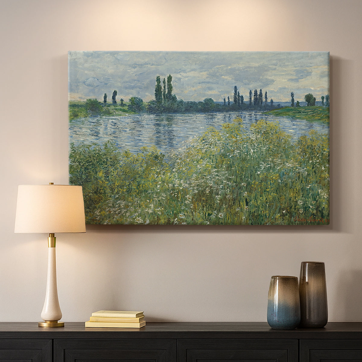 Canvas art print detailing a natural landscape with calm water and soft foliage, mounted in a softly lit interior space