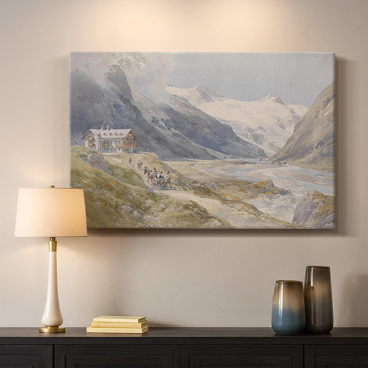 Canvas art print detailing a natural landscape with human presence among mountains, mounted in a softly lit interior space