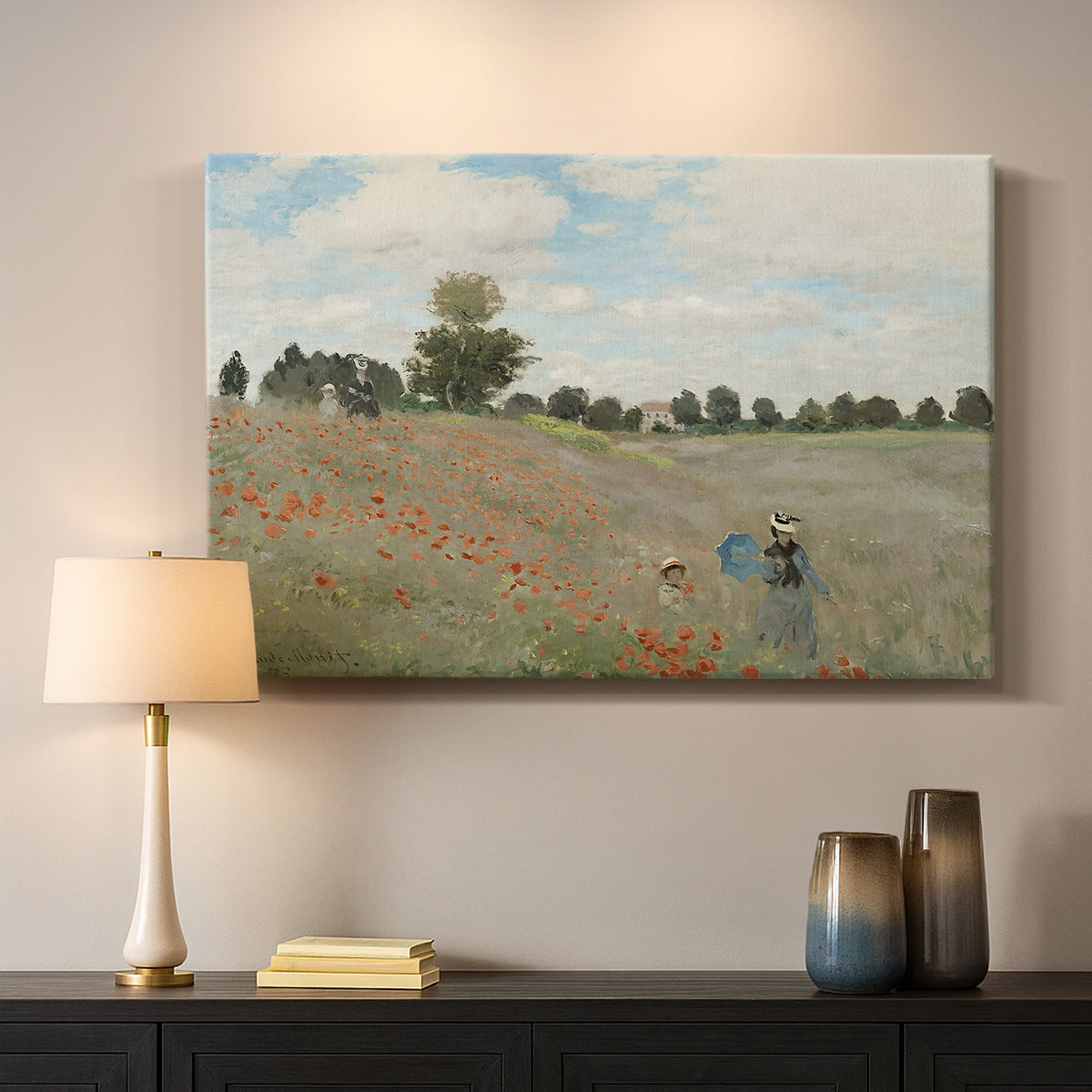Canvas art print detailing a rural landscape with scattered figures among blooming flowers, mounted in a softly lit interior space