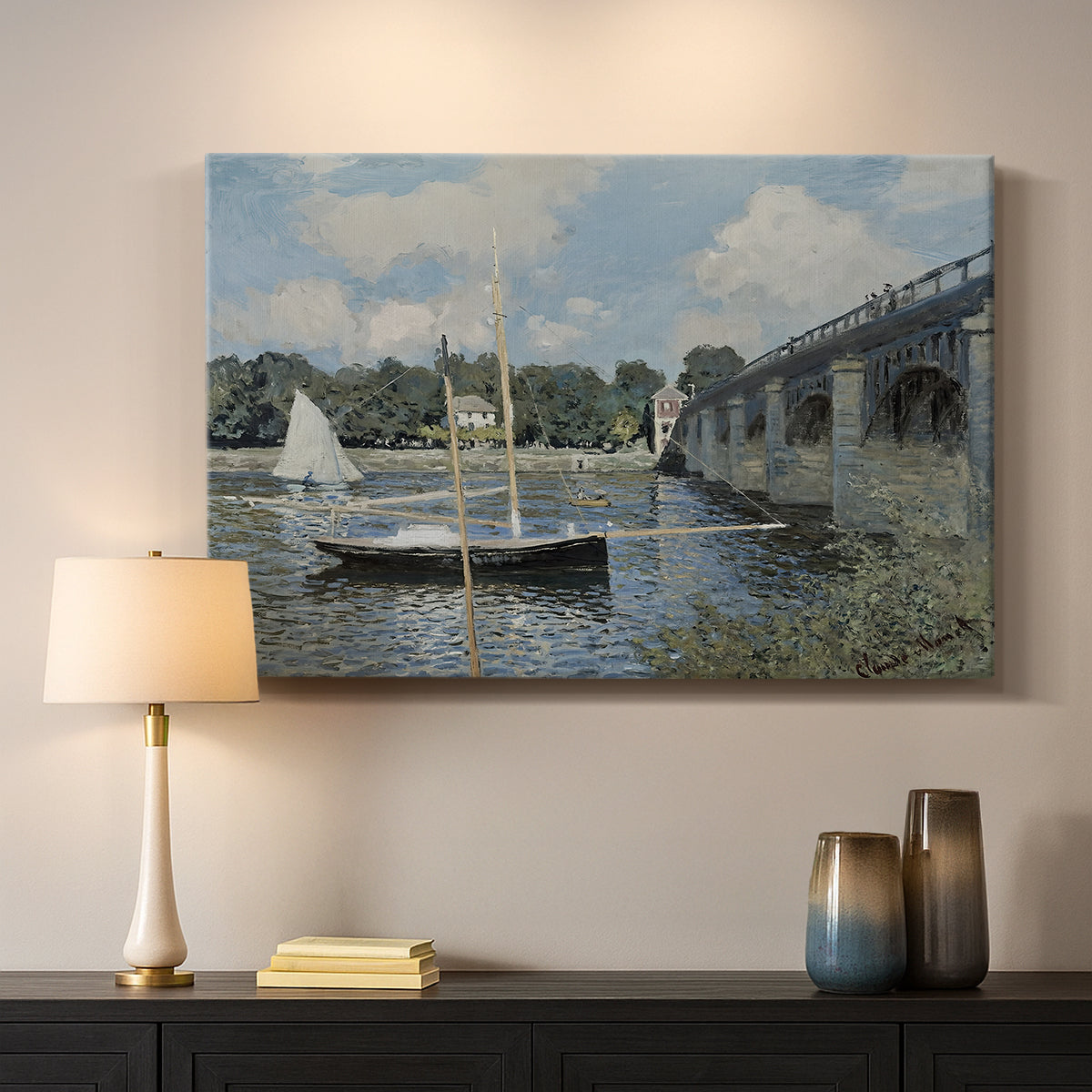 Canvas art print detailing a scenic riverscape with architecture and nautical activity, mounted in a softly lit interior space