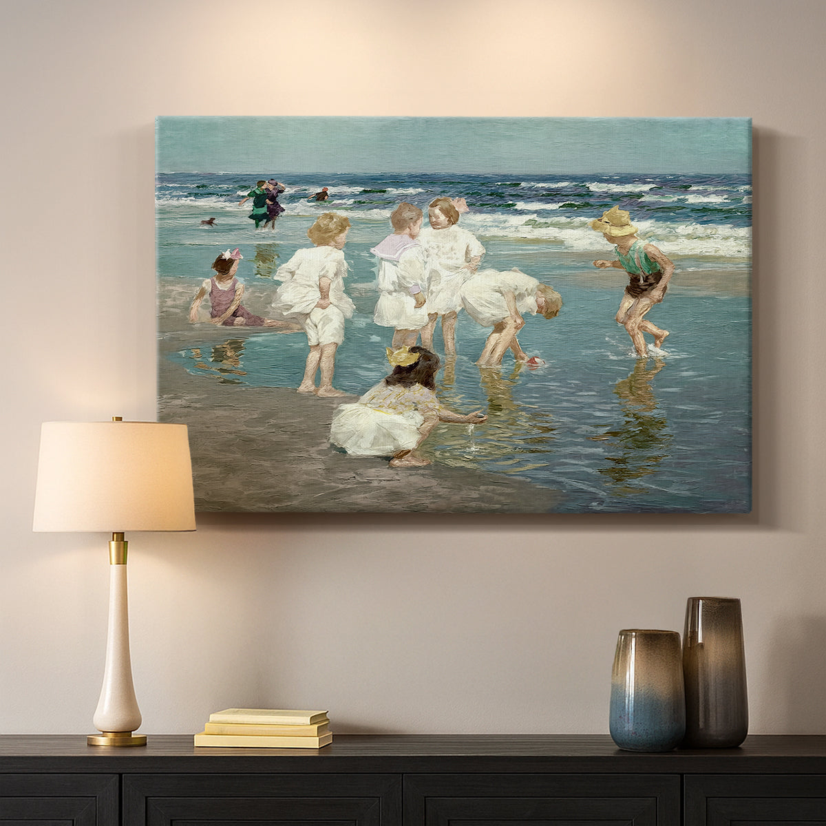 Canvas art print detailing a lively shoreline scene with people gathered in surf, mounted in a softly lit interior space