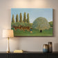 Canvas art print detailing a stylized rural setting with grassland and trees, mounted in a softly lit interior space