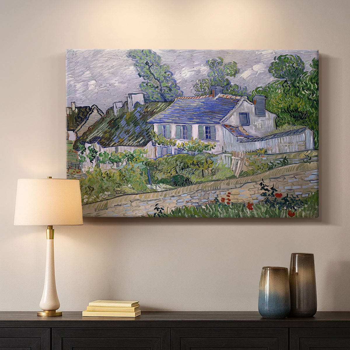 Canvas art print detailing a stylized composition featuring houses and landscape, mounted in a softly lit interior space