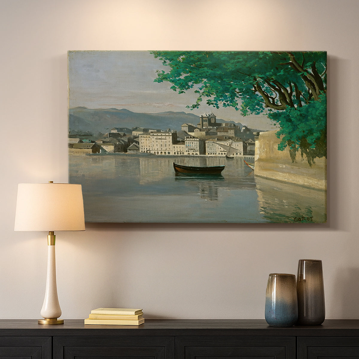 Canvas art print detailing a tranquil scene combining buildings, water, and sky, mounted in a softly lit interior space