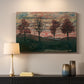 Canvas art print detailing an expressionist landscape featuring isolated trees in field, mounted in a softly lit interior space