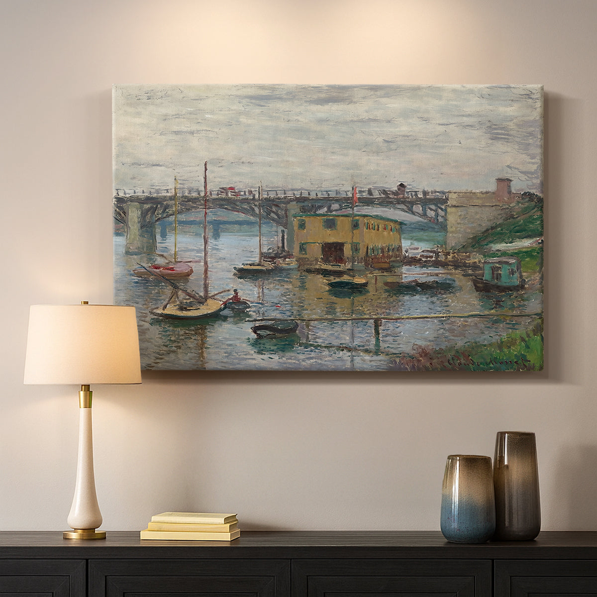 Canvas art print detailing a subdued urban landscape with structure spanning river, mounted in a softly lit interior space