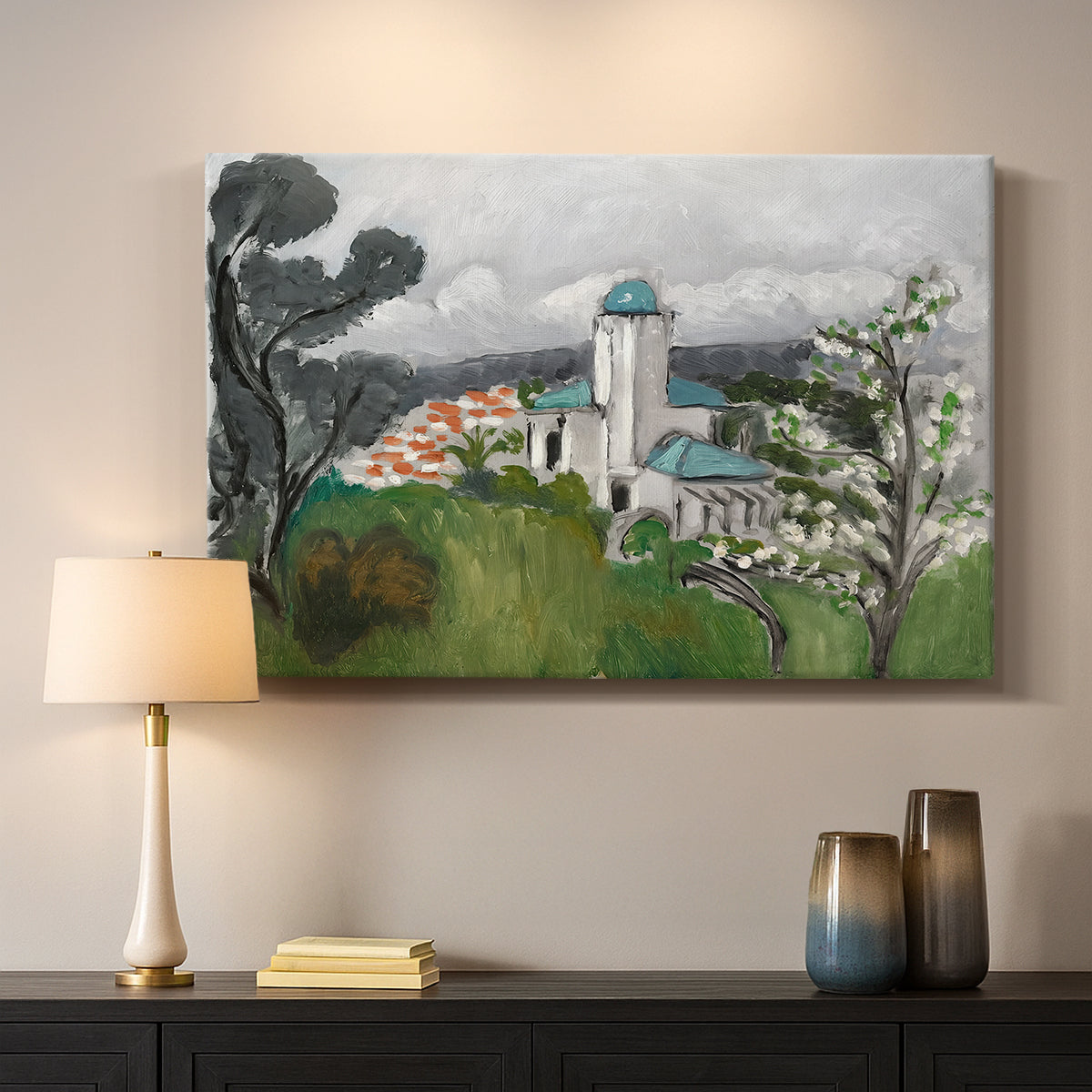 Canvas art print detailing a colorful scene of a villa among trees and vegetation, mounted in a softly lit interior space