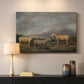 Canvas art print detailing a realistic depiction of sheep in countryside, mounted in a softly lit interior space