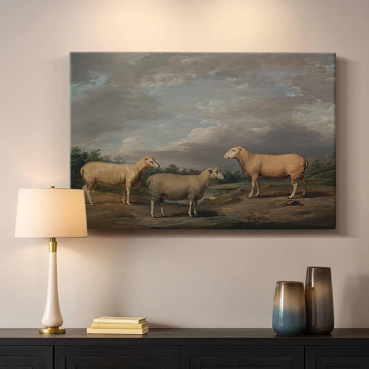 Canvas art print detailing a realistic depiction of sheep in countryside, mounted in a softly lit interior space