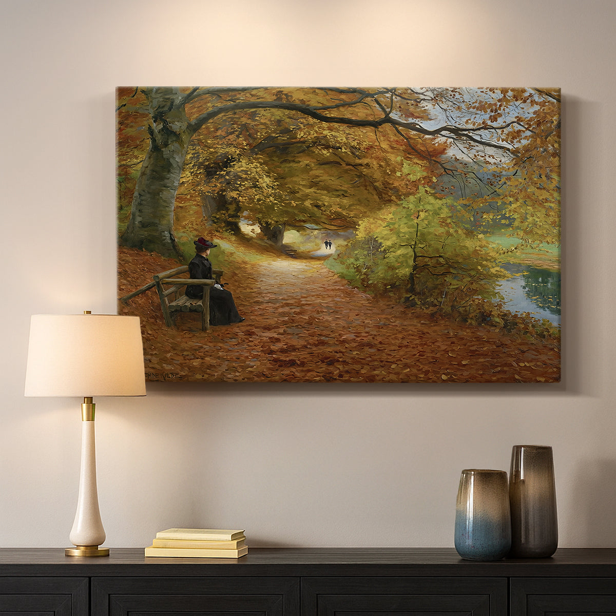 Canvas art print detailing a peaceful autumn setting with figures in wooded environment, mounted in a softly lit interior space