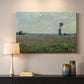 Canvas art print detailing a natural field scene with vibrant red flowers, mounted in a softly lit interior space
