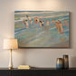 Canvas art print detailing a coastal scene with children and reflective shoreline, mounted in a softly lit interior space