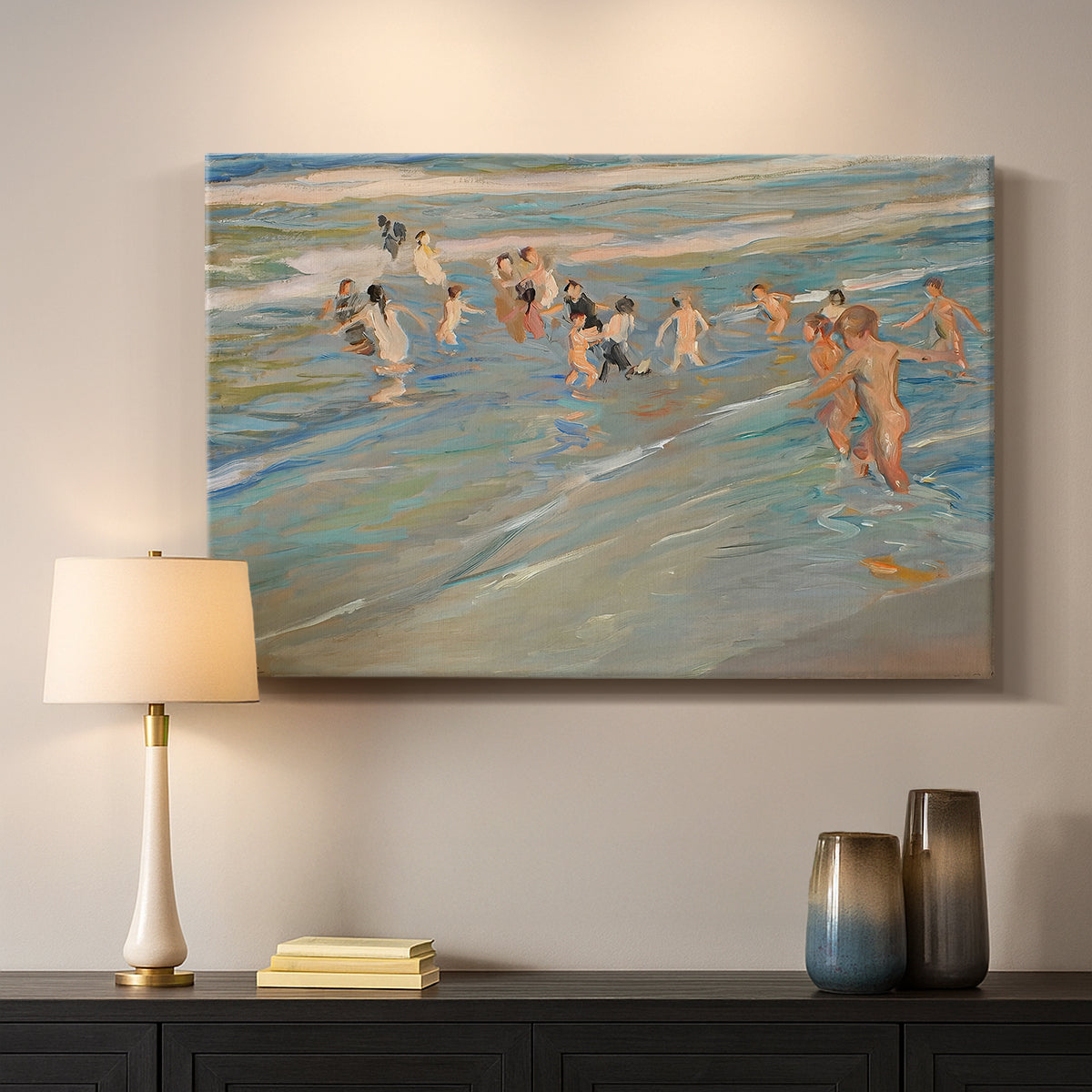 Canvas art print detailing a coastal scene with children and reflective shoreline, mounted in a softly lit interior space
