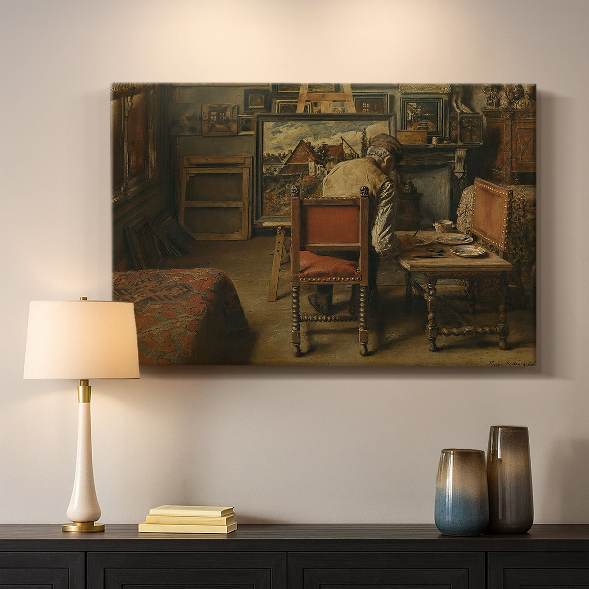 Canvas art print detailing a quiet workspace with figure engaged in artistic task, mounted in a softly lit interior space