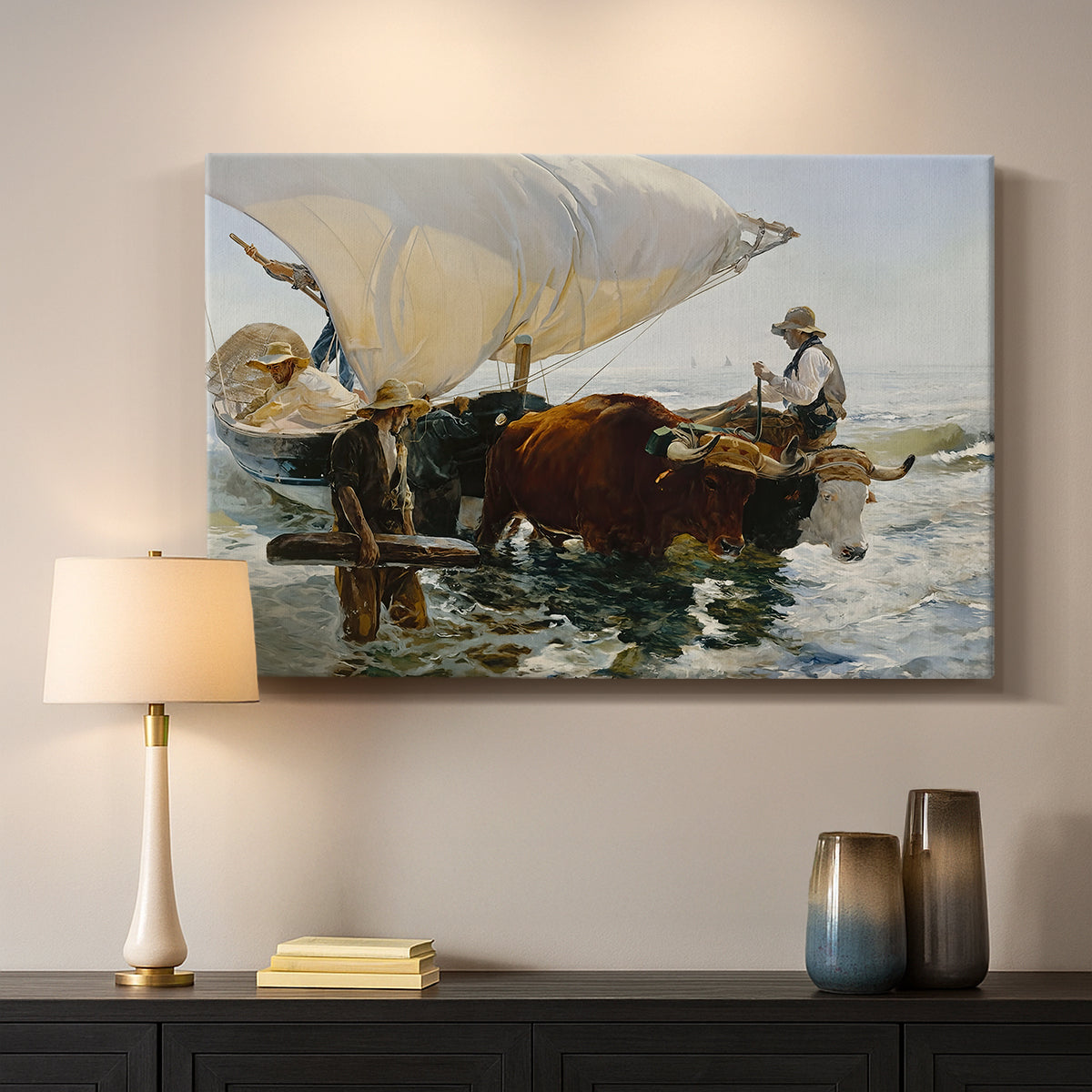 Canvas art print detailing an impressionist beach scene showing teamwork, mounted in a softly lit interior space