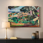Canvas art print detailing a stylized coastal landscape with buildings and trees, mounted in a softly lit interior space