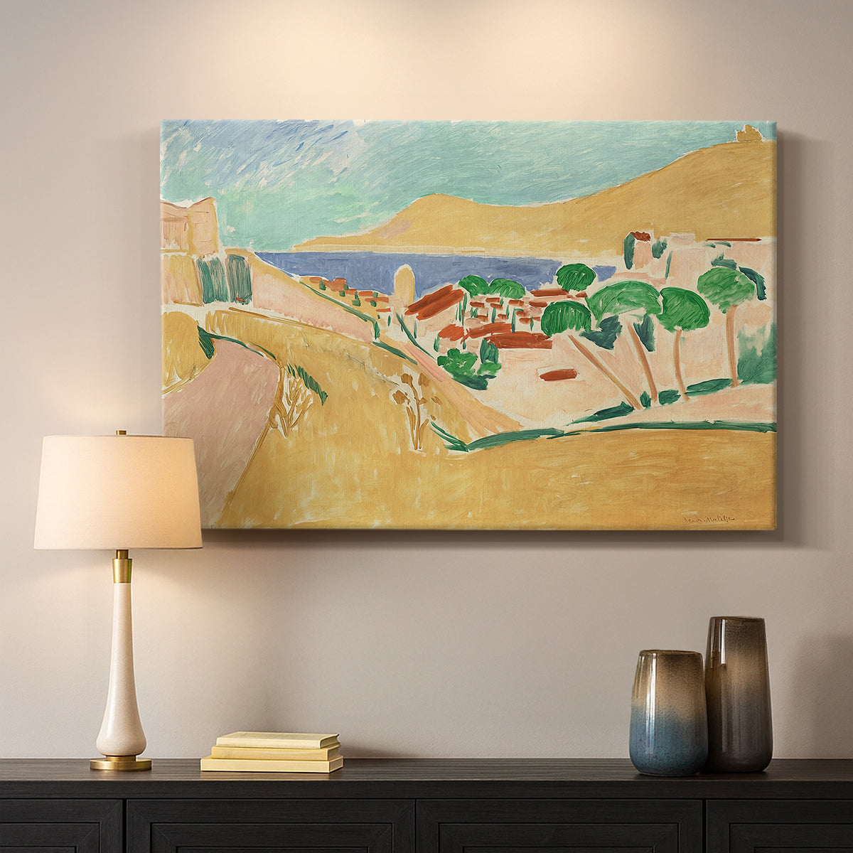 Canvas art print detailing a colorful village scene with water and architecture, mounted in a softly lit interior space