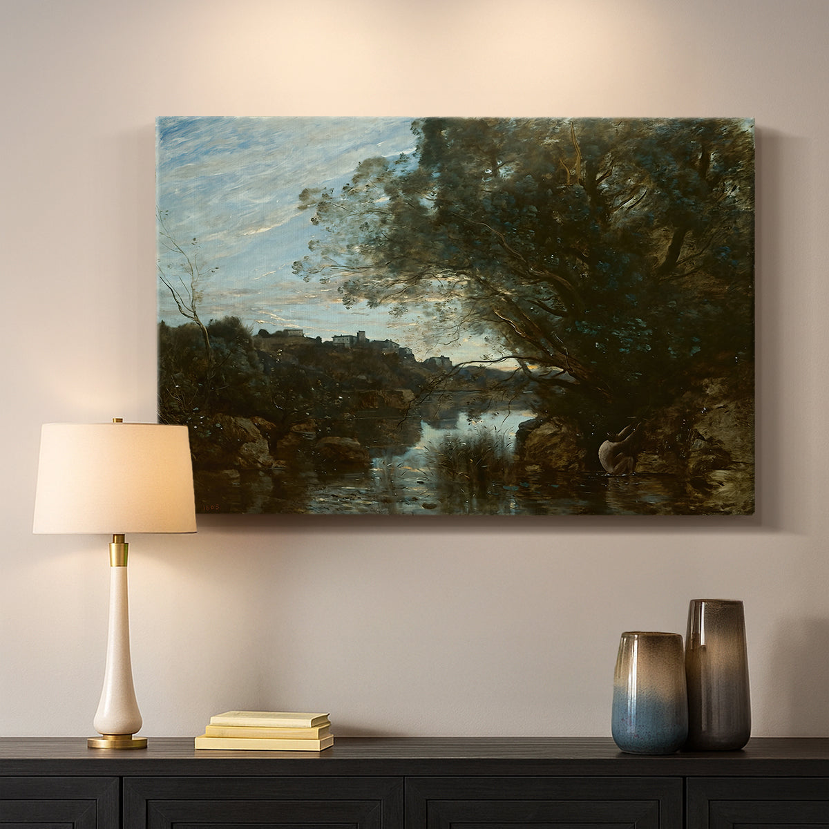 Canvas art print detailing a tranquil setting with water, trees, and horizon, mounted in a softly lit interior space