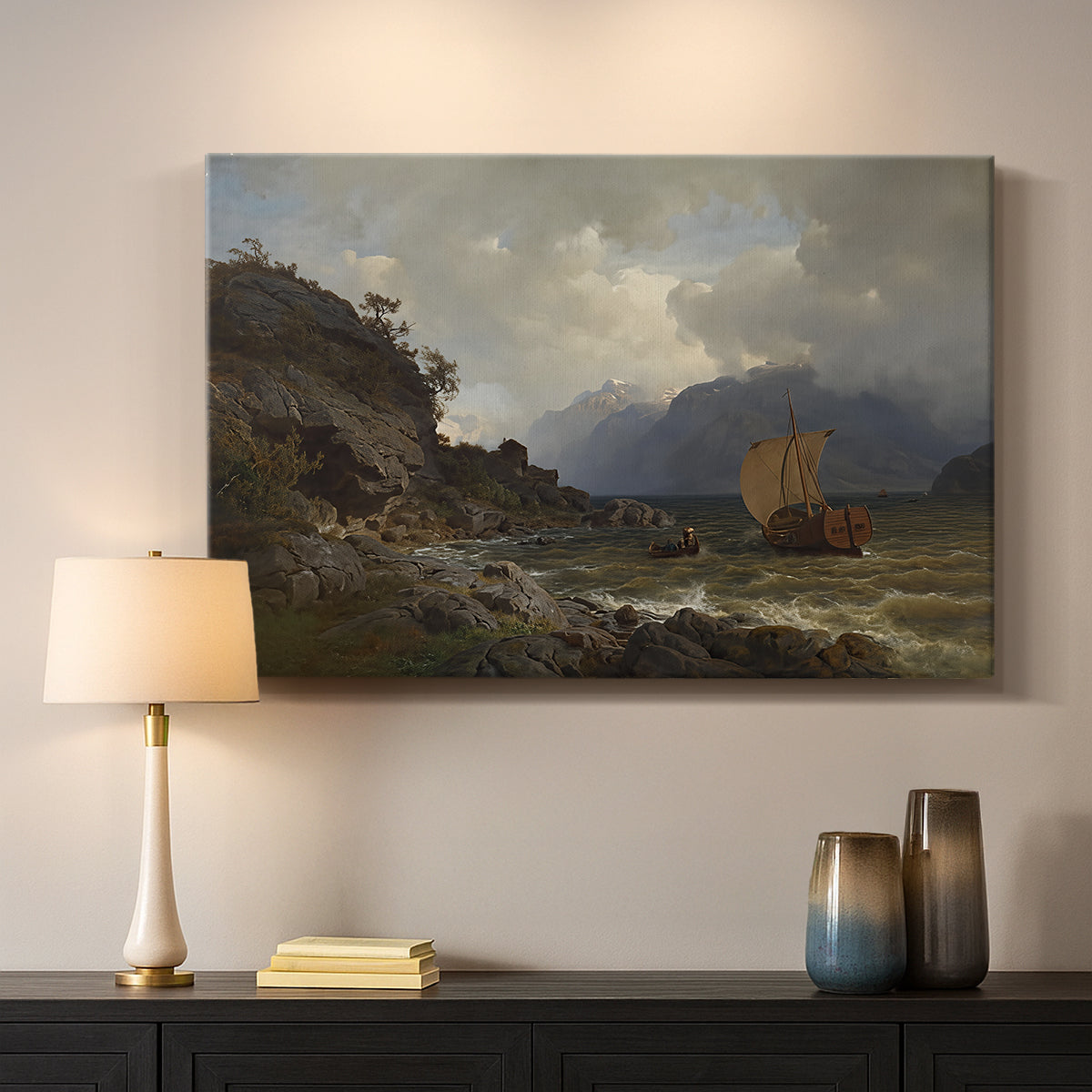 Canvas art print detailing a Nordic coastal scene with waves and distant vessels, mounted in a softly lit interior space