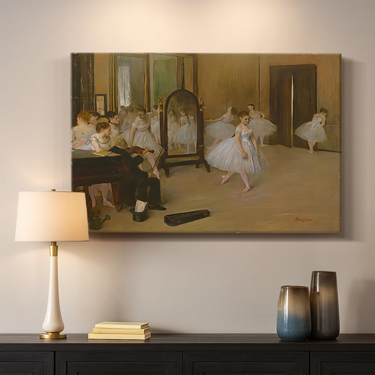 Canvas art print detailing a group of dancers mid-practice with teacher overseeing, mounted in a softly lit interior space