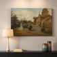 Canvas art print detailing a street view centered on building and surrounding structures, mounted in a softly lit interior space