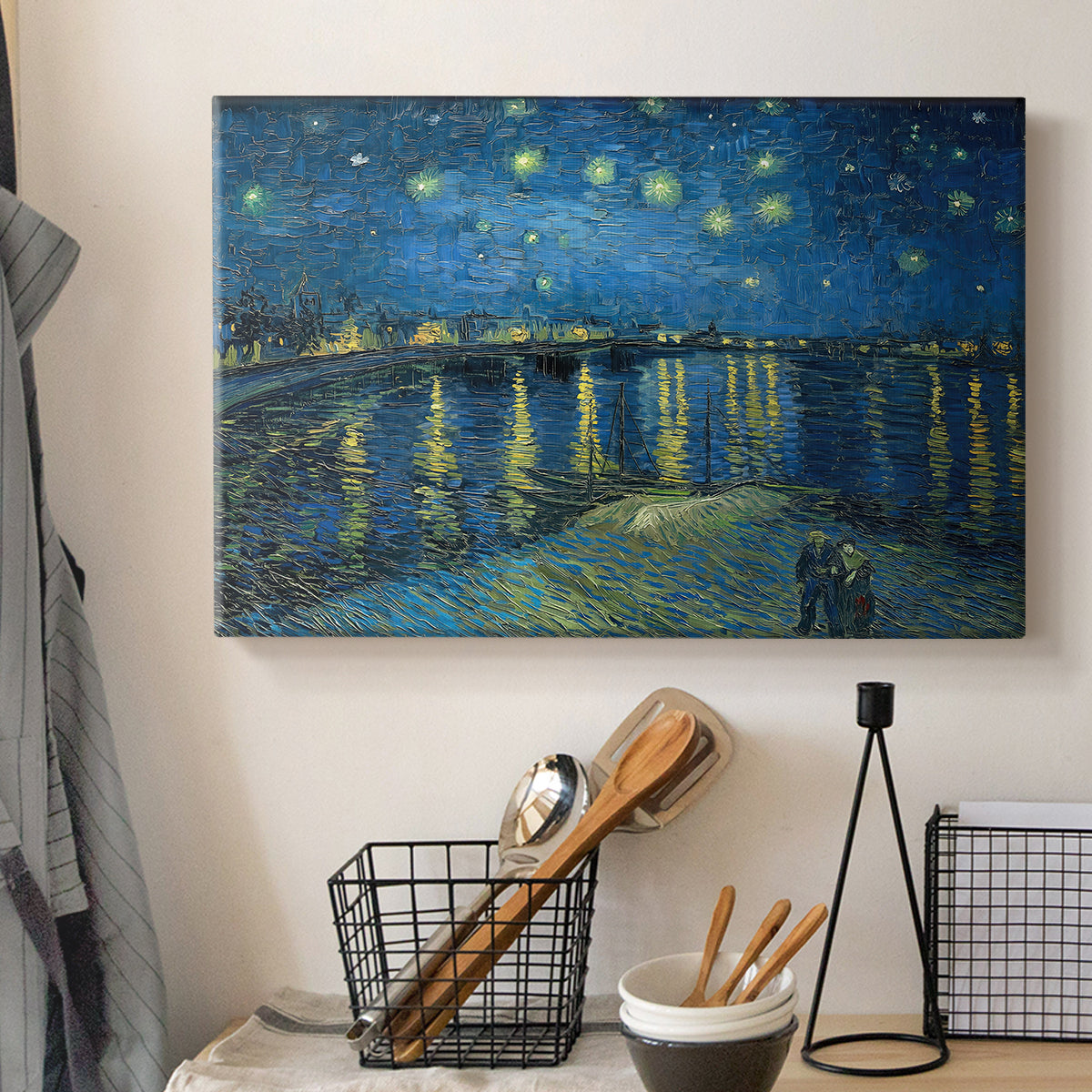 Canvas art print detailing a stylized night composition with river and celestial elements, displayed in a softly lit workspace setting