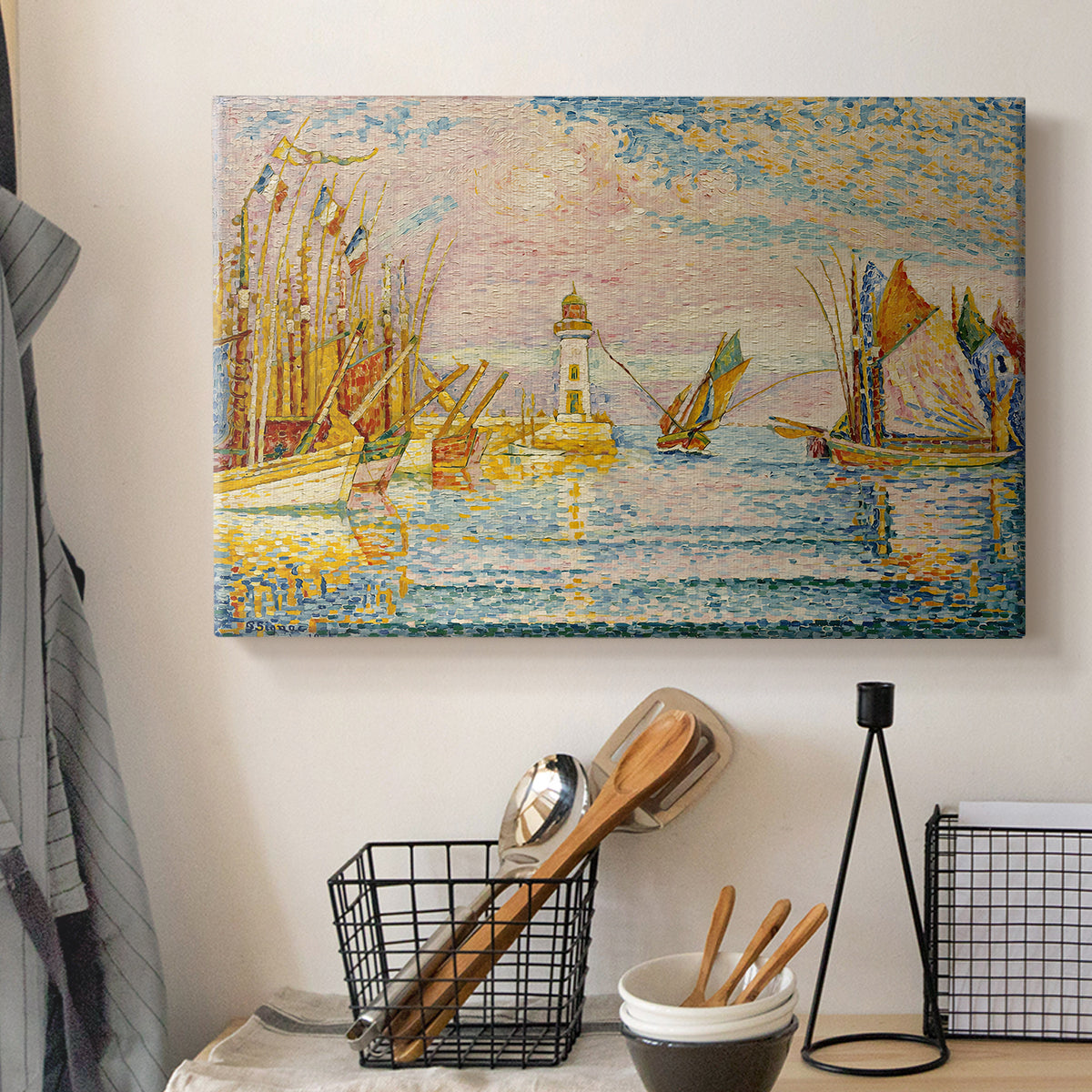 Canvas art print detailing a maritime structure and ships, displayed in a softly lit workspace setting