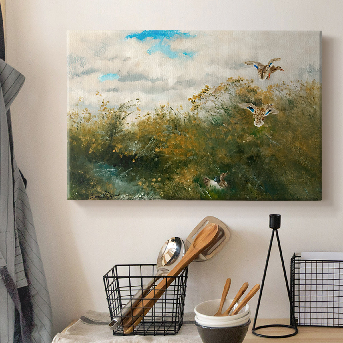 Canvas art print detailing a realistic depiction of ducks in countryside landscape, displayed in a softly lit workspace setting