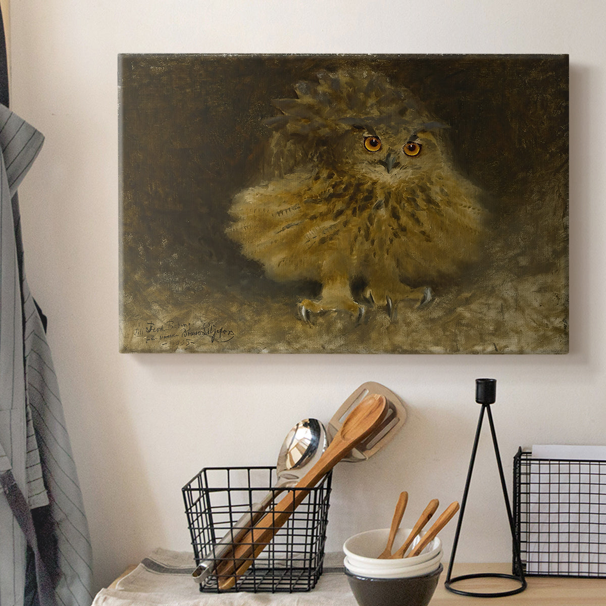 Canvas art print detailing a realistic depiction of owl camouflaged within woodland environment, displayed in a softly lit workspace setting