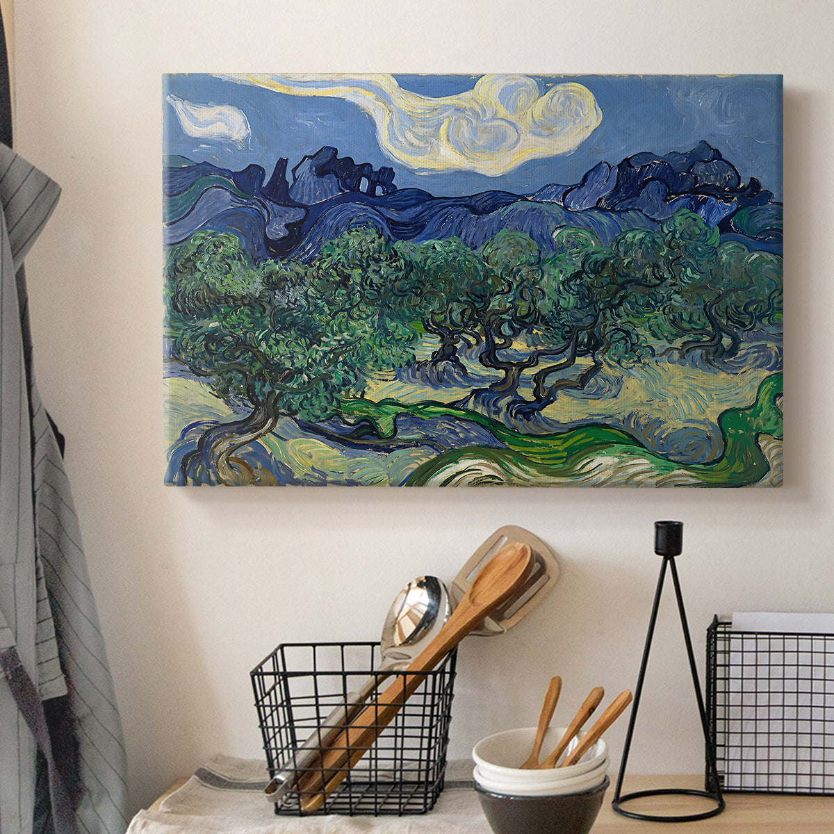 Canvas art print detailing a rural composition emphasizing contrast between trees and mountains, displayed in a softly lit workspace setting