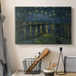 Canvas art print detailing a nocturnal landscape emphasizing contrast between lights and dark water, displayed in a softly lit workspace setting
