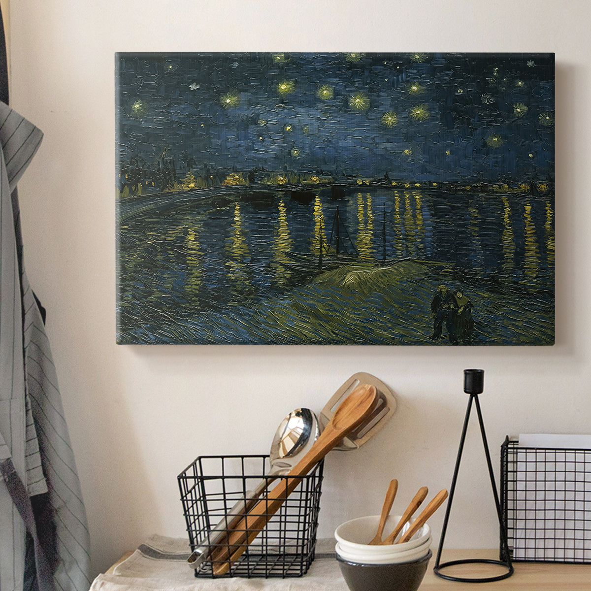 Canvas art print detailing a nocturnal landscape emphasizing contrast between lights and dark water, displayed in a softly lit workspace setting