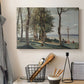Canvas art print detailing a tranquil setting with cross and surrounding vegetation, displayed in a softly lit workspace setting