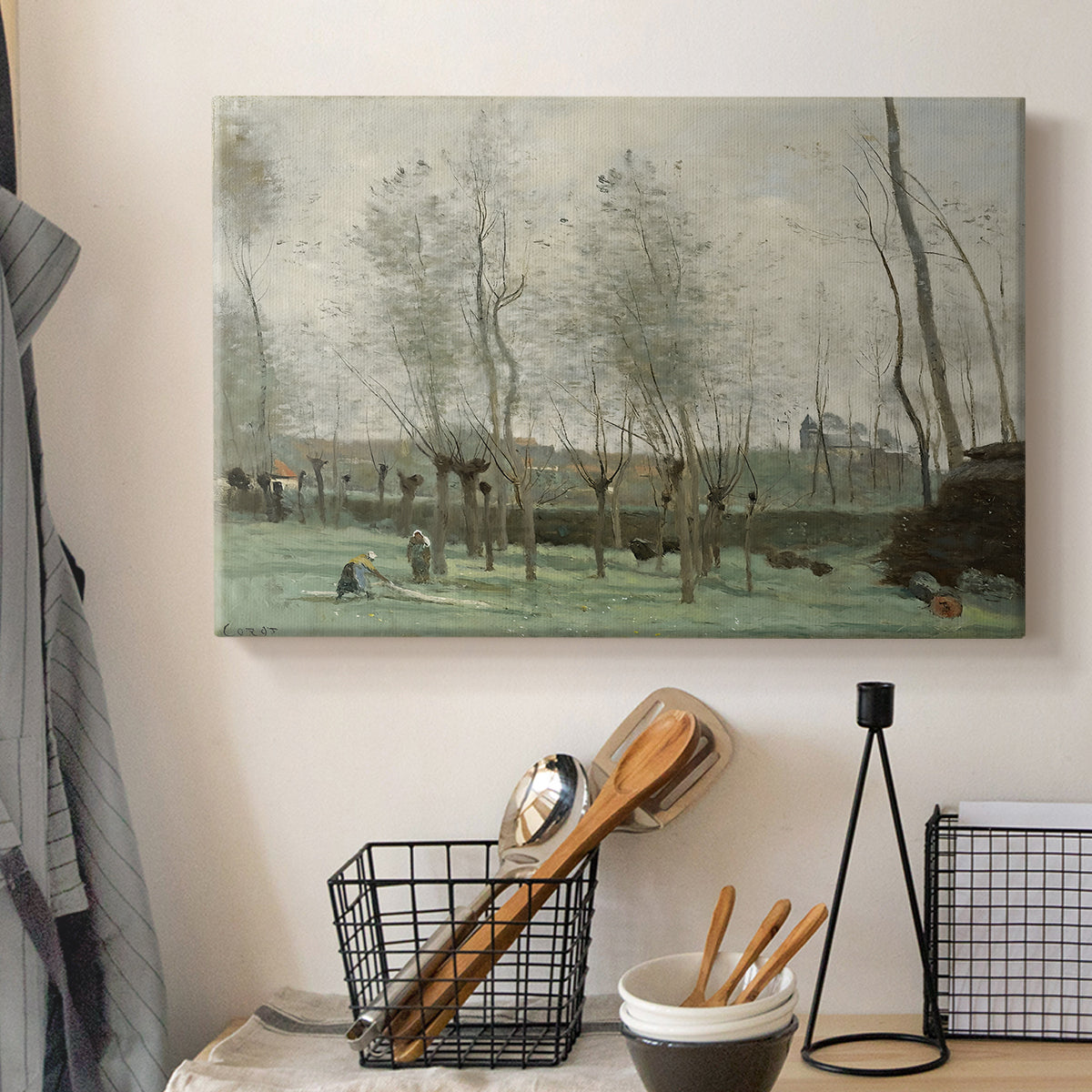 Canvas art print detailing a tranquil outdoor scene with washerwomen and foliage, displayed in a softly lit workspace setting