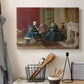 Canvas art print detailing a family group portrait with warm interior tones, displayed in a softly lit workspace setting