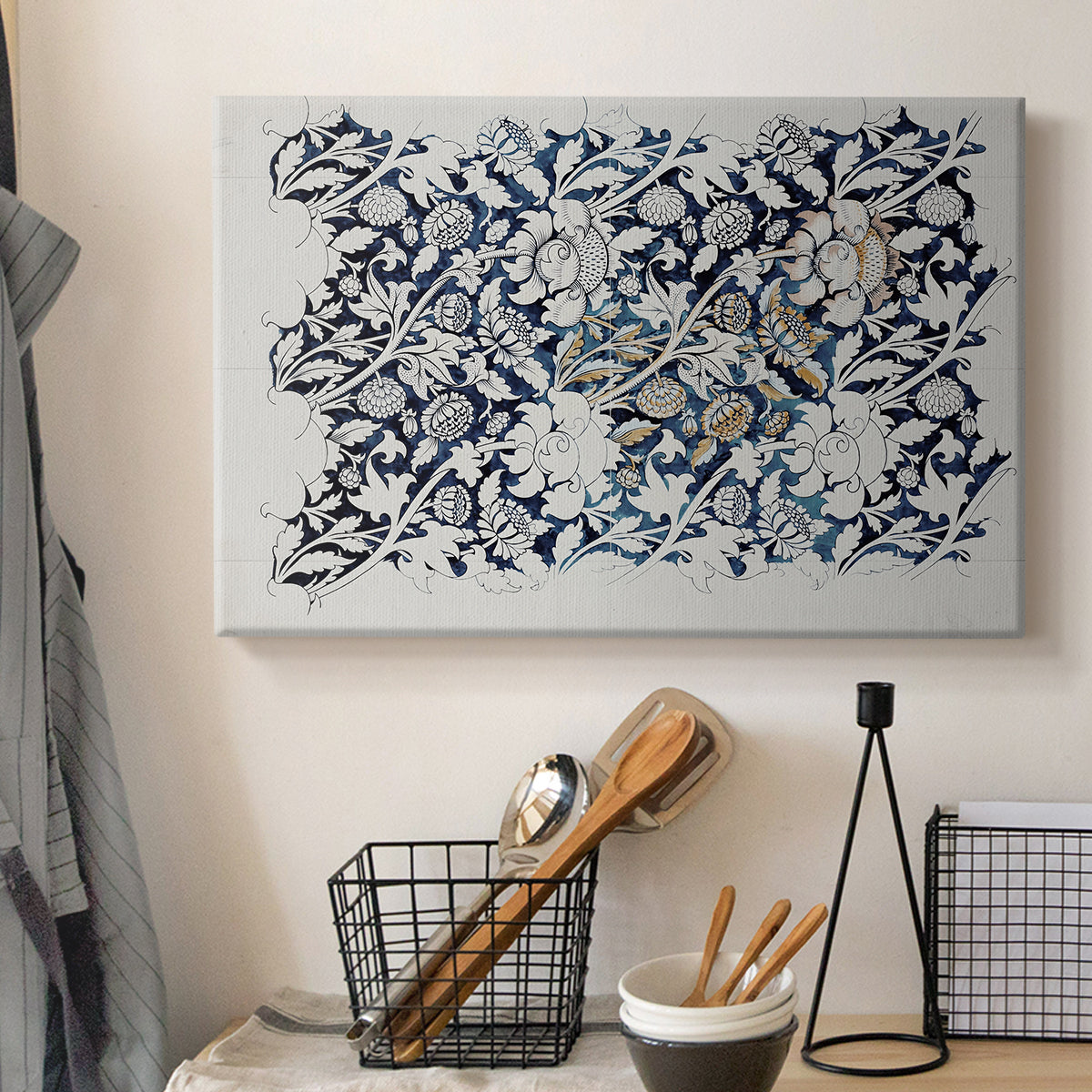 Canvas art print detailing a botanical pattern with fluid arrangement of flowers and foliage, displayed in a softly lit workspace setting